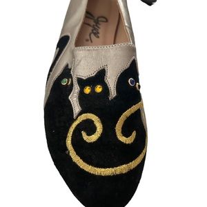 Adorable flats with black cat appliqués on a metallic background